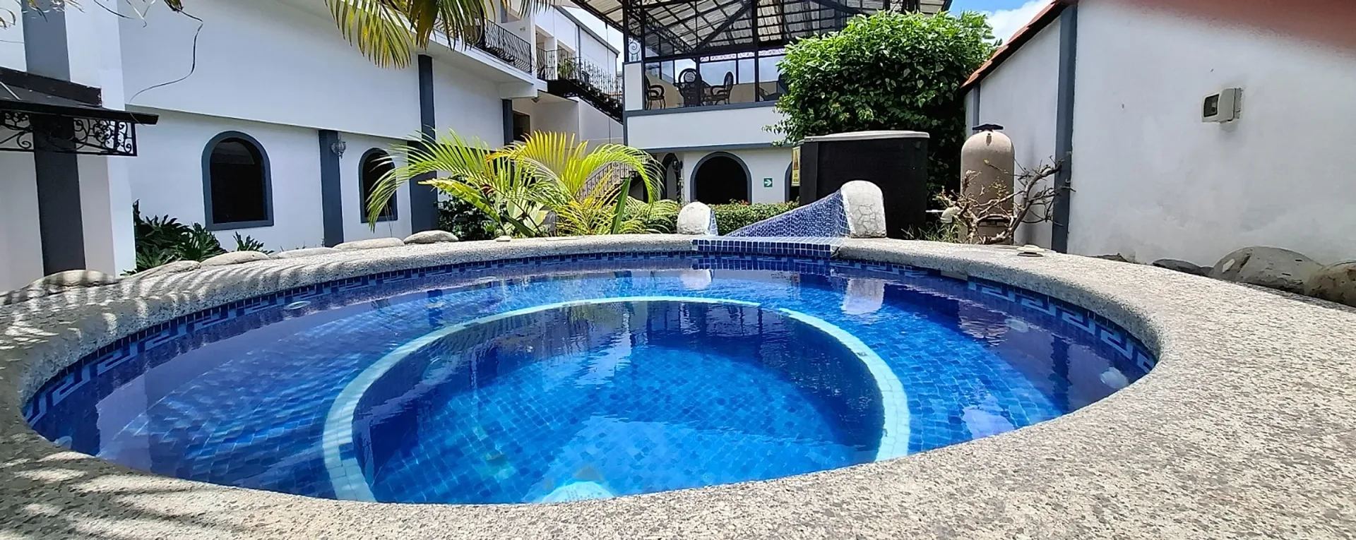 Tropical pool and restored mansion at Hotel Santo Tomás